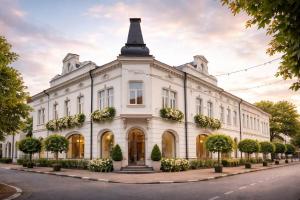 a white building with a tower on top of it at Віенер in Stryi
