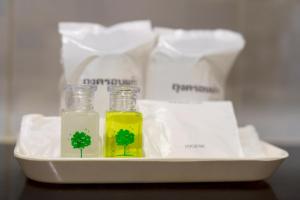 two bottles of oil and a tree in a tray at The Ring Hotel in Hat Yai +72 photos