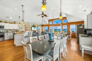 a kitchen and dining room with a table and chairs at 7000 - Serenity Sands in Whalebone