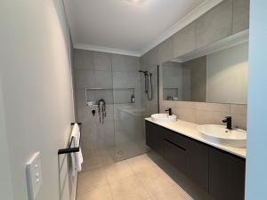 a bathroom with two sinks and a shower and a tub at Wyoming Ave in North Wagga +24 photos