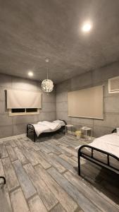 a room with two beds and a projection screen at شقق رواق in Abha