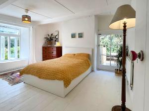 a bedroom with a bed and a lamp in it at Gara Mill Cottage in Kingsbridge +24 photos