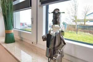 a mannequin standing in front of a window at Ferienhaushälfte "Ausblick" in Sundhagen-Niederhof