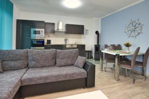 a living room and kitchen with a couch and a table at Ferienhaushälfte "Ausblick" in Sundhagen-Niederhof +37 photos