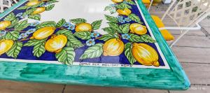 a table with a painting of lemons on it at Domus DEA Holiday Home in Pompei