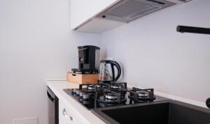 a kitchen with a stove with a coffee maker on it at Hortus slow room in Montesarchio