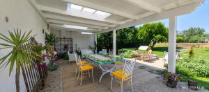 a patio with a table and chairs on it at Domus DEA Holiday Home in Pompei