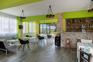 a restaurant with a fireplace and a green wall at Ilios and Irene 5 in Mastihari