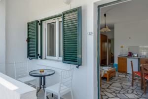a room with a table and a window at Ilios and Irene 5 in Mastihari +23 photos