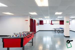 a room with a foosball table in the middle at Hotiday Bordighera in Bordighera