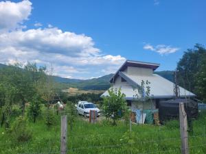 a white car parked in front of a house at Vila Boutique Cozy in Nucşoara