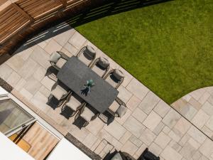 an overhead view of a patio with chairs and a lawn at Upper Oak House in Windermere