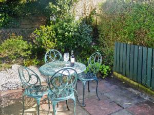 a table with four chairs and a bottle of wine at Chy-Vean in Madron
