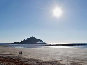 a couple of people walking on the beach at Chy-Vean in Madron