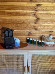 a shelf with a coffee maker and several green cups at UCamp Kemmelberg in Heuvelland +28 photos