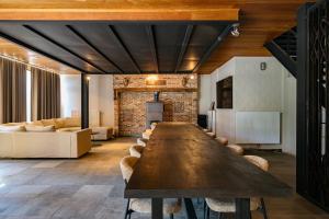 a large wooden table in a room with chairs at Vakantiewoning - Camping Groenpark in Berlare