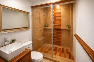 a bathroom with a shower and a sink at Feliz Puerta - Entire House with Rooftop Terrace, Iquitos in Iquitos +10 photos