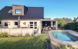 a house with a swimming pool in the yard at Stunning Home In Sæby in Sæby