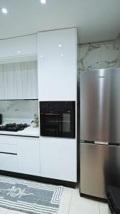 a kitchen with a stainless steel refrigerator and a stove at Chez-moi in Sfax +11 photos