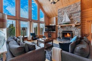 a living room with two couches and a fireplace at Spa Pool & Sauna - Laurentides Serenity in Mille-Isles