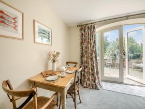 a dining room with a table and a window at Nightfold - Uk49890 in Preston