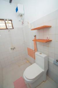 a bathroom with a white toilet in a room at Bahari Studio Apartment in Bwejuu +22 photos