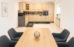 a kitchen with a wooden table and two chairs at Ferienwohnung Birke in Sankt Wendel