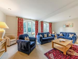 a living room with blue chairs and a table at Carriage House - Uk49288 in Preston