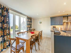 a kitchen and dining room with a wooden table and chairs at Carriage House - Uk49288 in Preston