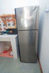 a stainless steel refrigerator in a kitchen next to a counter at Bahari Studio Apartment in Bwejuu