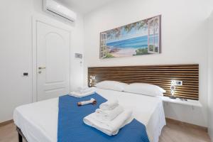 a bedroom with a bed with towels on it at Bikers Rooms in Sestu