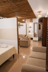 a living room with a bed and a couch at Feliz Puerta - Entire House with Rooftop Terrace, Iquitos in Iquitos