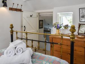 a bedroom with a bed with towels on it at Tan Bryn - Uk44151 in Llanallgo +5 photos