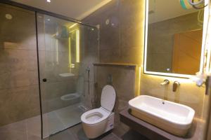 a bathroom with a toilet and a sink and a shower at Chunmun Elite Retreat in Bulandshahr