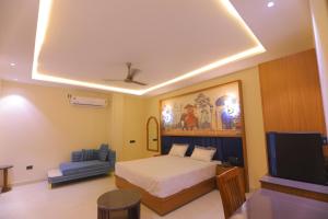a bedroom with a bed and a flat screen tv at Chunmun Elite Retreat in Bulandshahr