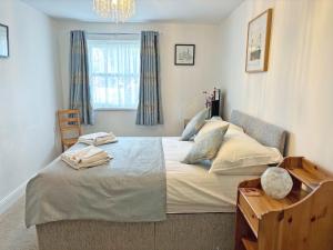 a bedroom with a large bed and a window at 11 Elm Court in Keswick