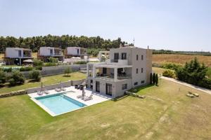 an aerial view of a house with a swimming pool at Sani Invictus Villa in Sani Beach