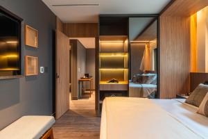 a hotel room with two beds and a bedroom at Laghetto Stilo São Paulo in São Paulo