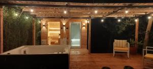 a bath tub sitting on a patio with a chair at Barnhouse Cottage - Sauna & Steam bath - in Tigoni in Nairobi +40 photos