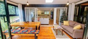 a living room with a couch and a table at Barnhouse Cottage - Sauna & Steam bath - in Tigoni in Nairobi
