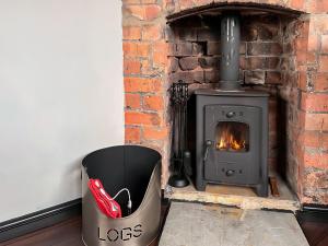 a fireplace with a trash can in front of it at The Weighbridge in North Clifton