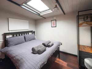 a bedroom with a bed with two pillows on it at The Weighbridge in North Clifton