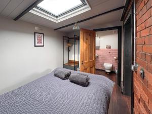 a bedroom with a bed with two pillows on it at The Weighbridge in North Clifton +6 photos