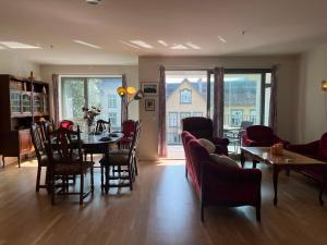 a living room with a table and chairs at Spacious Apartment - Prime Voss Location - Elevator in Vossevangen +25 photos
