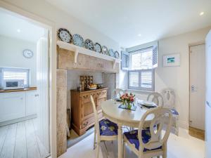a kitchen and dining room with a table and chairs at Chareside Cottage in Corbridge