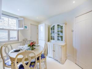 a kitchen with a dining room table and chairs at Chareside Cottage in Corbridge