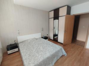 a bedroom with a bed and a dresser and a closet at The Urban Point Dobrich in Dobrich