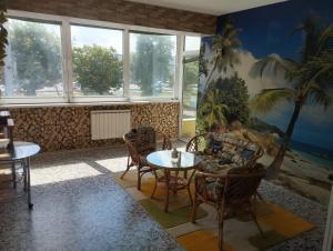 a living room with a table and chairs at The Urban Point Dobrich in Dobrich