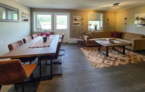 a living room with a table and a couch at Gorgeous Apartment In Drangedal in Drangedal