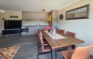 a dining room with a wooden table and chairs at Gorgeous Apartment In Drangedal in Drangedal